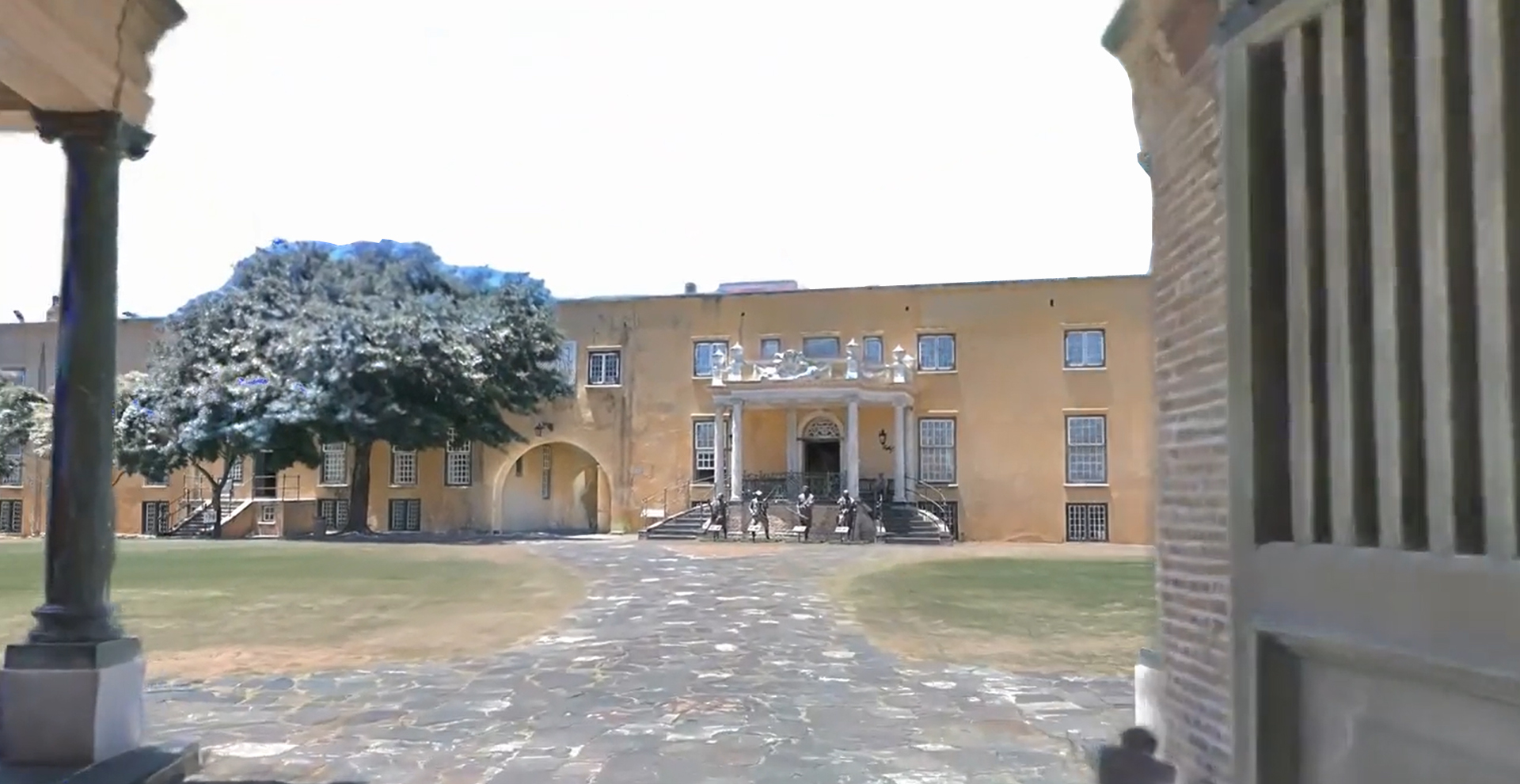 Gaussian splat 3D capture of building exterior courtyard showing real-world lighting and depth